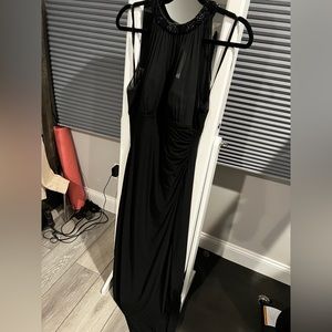 Floor length black gown with halter neck and sequin detail.